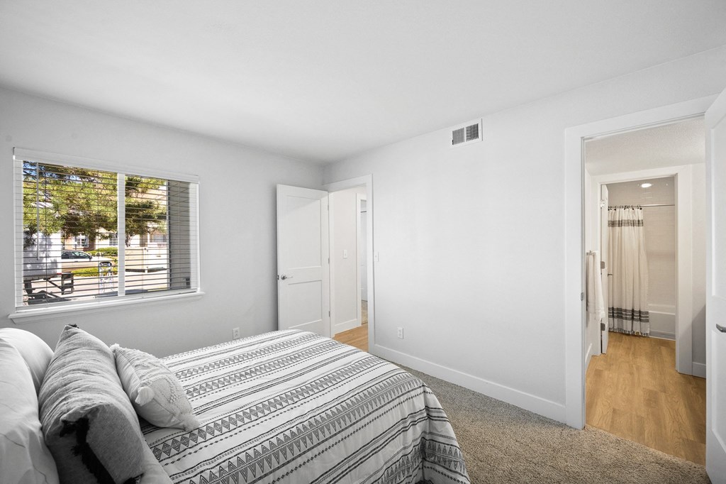 a bedroom with a bed and a window