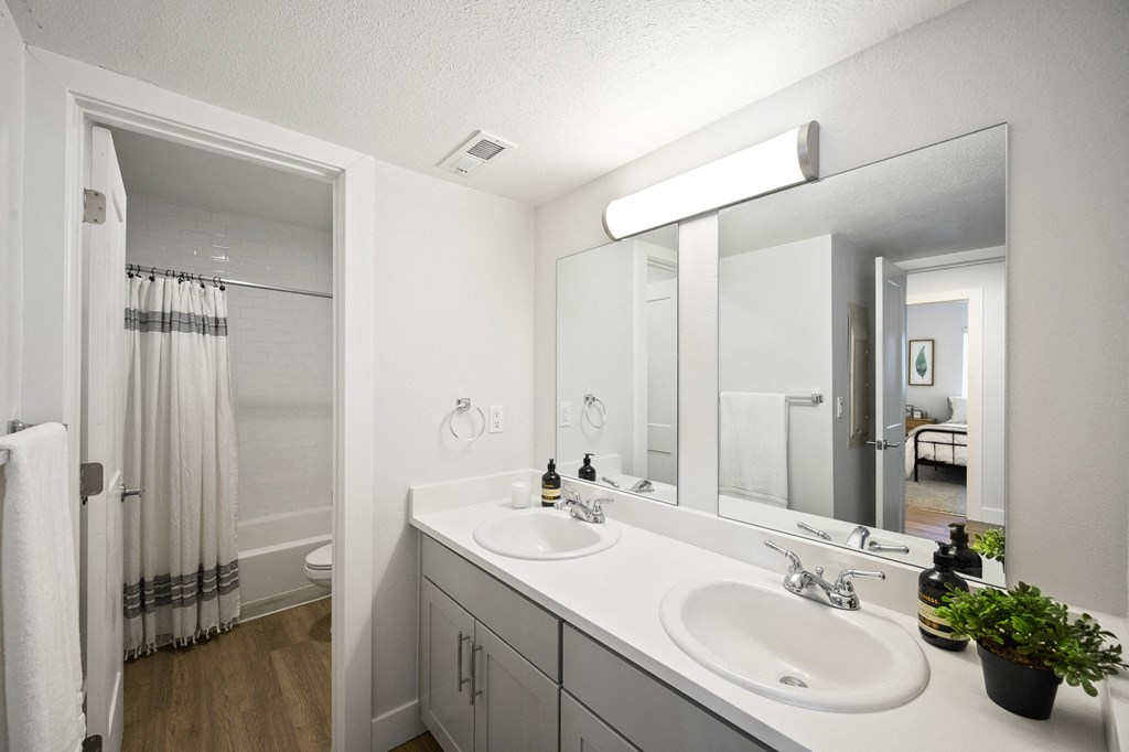 the preserve at ballantyne commons apartment bathroom with two sinks and a shower
