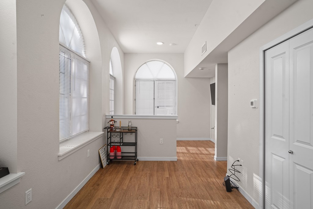 A room with wooden floors and white walls.
