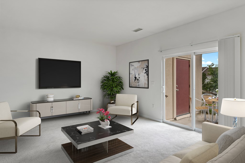 A living room with a flat screen TV mounted on the wall.