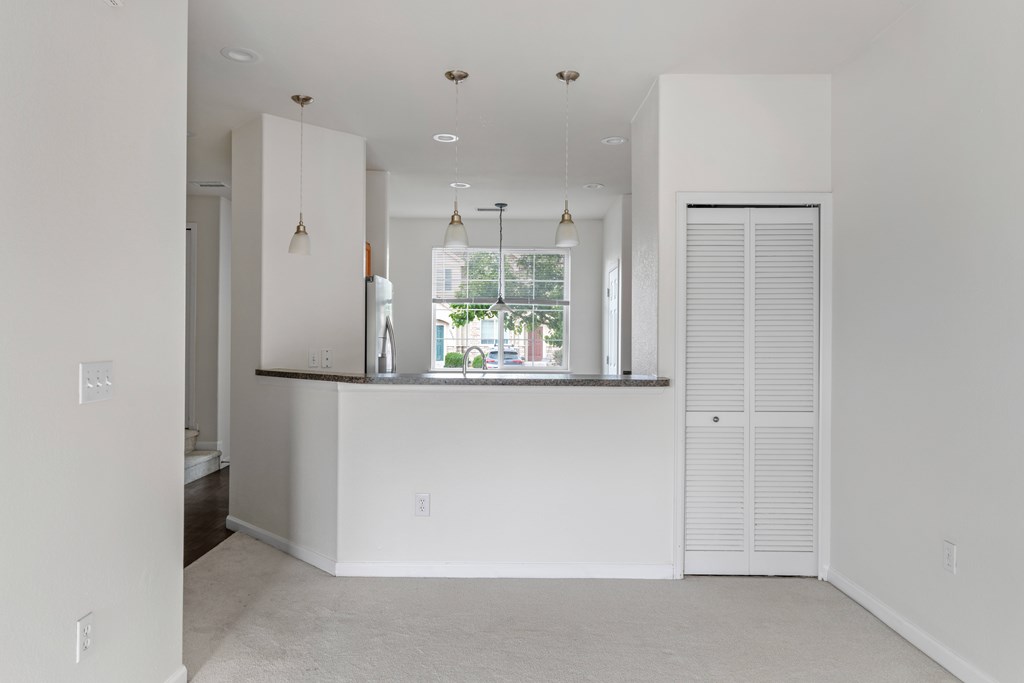 A white room with a window and a counter.