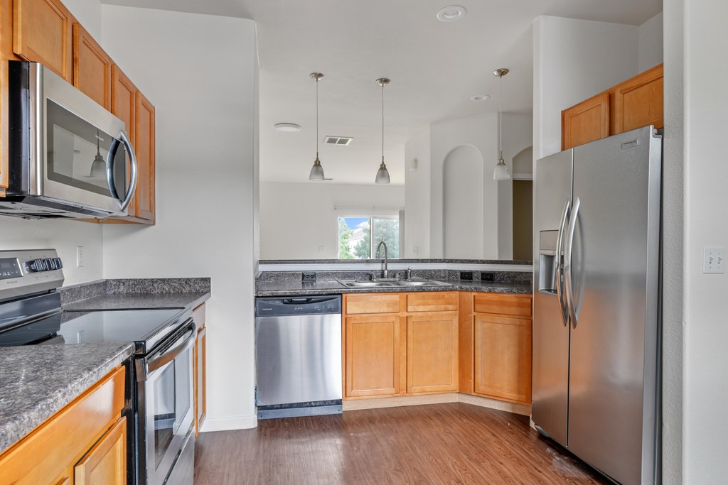 A kitchen with wooden cabinets and stainless steel appliances.