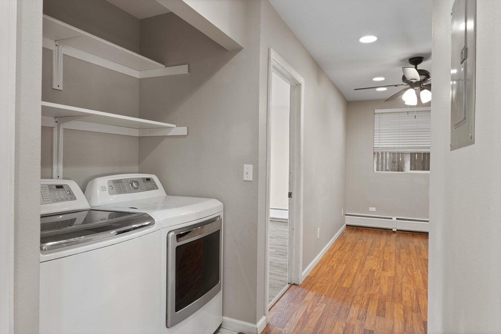 A small laundry room with a washer and dryer.
