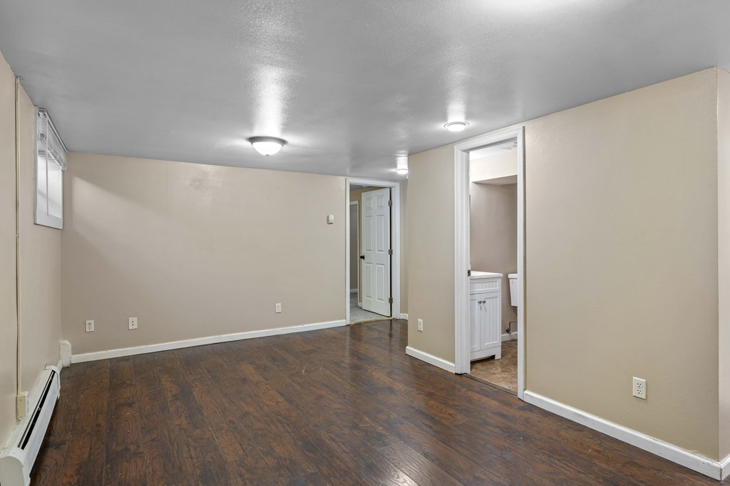 A room with a wooden floor and white walls.