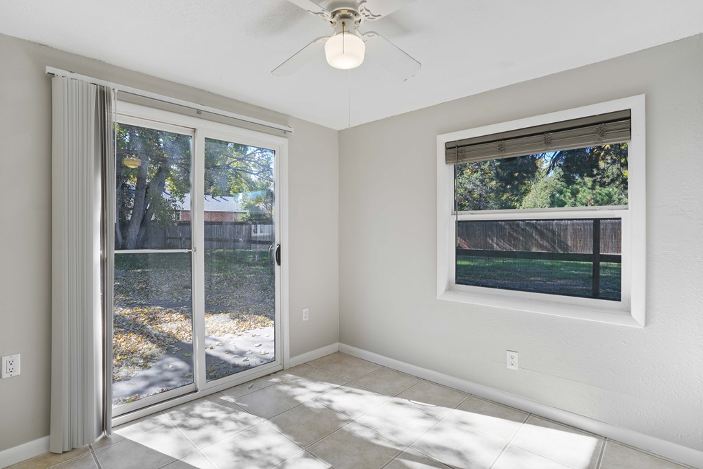 A room with a sliding glass door leading to a backyard.