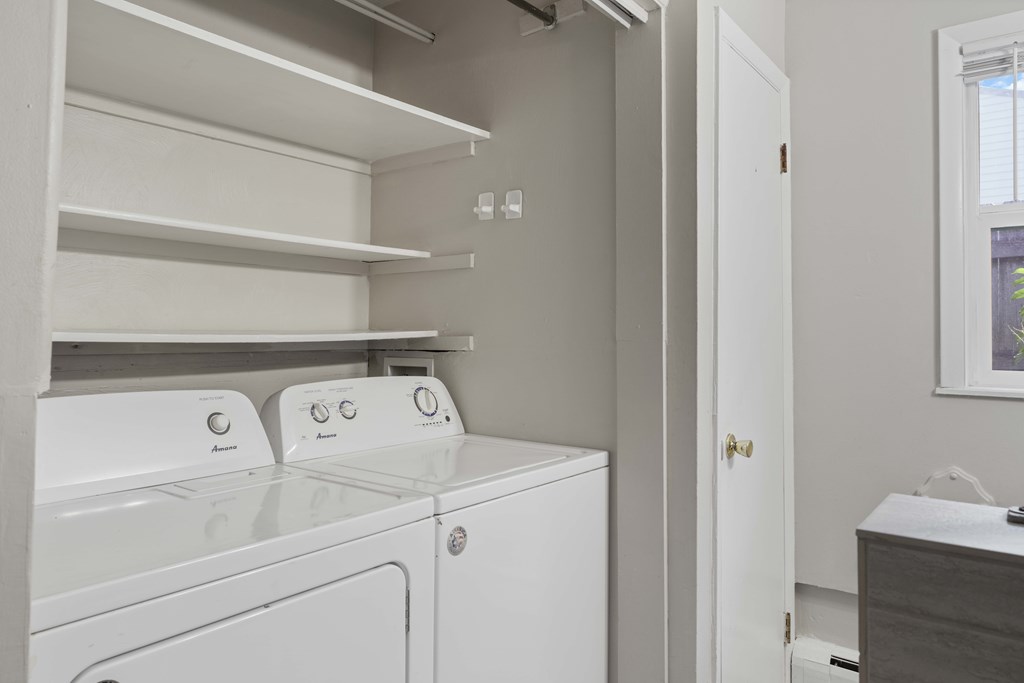 A white washing machine and dryer in a laundry room.