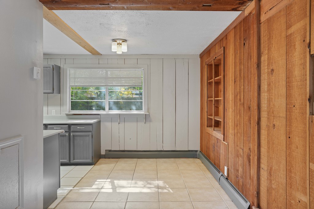 A kitchen with wooden cabinets and a window.