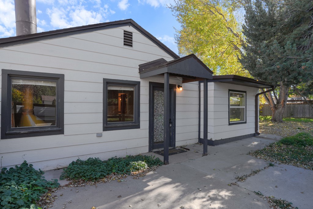 A small house with a black door and windows.