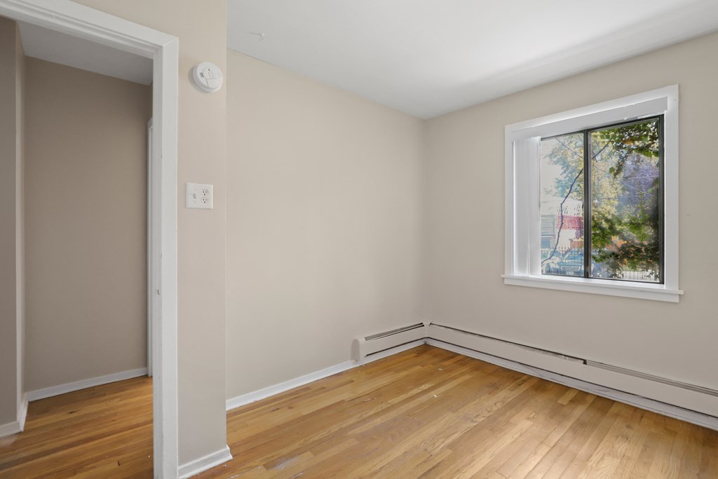 a living room with wood floors and a window