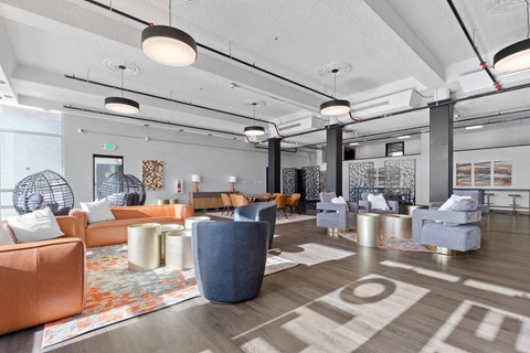 A modern living room with a variety of seating options and a patterned rug.