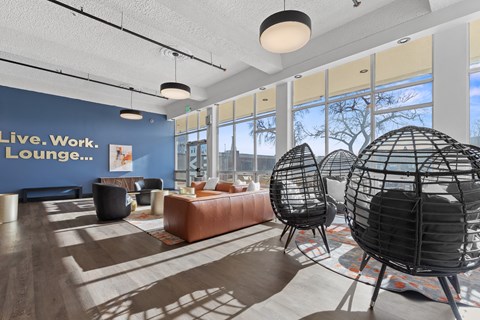 A room with a sign that says "Live. Work. Lounge..." on the wall.