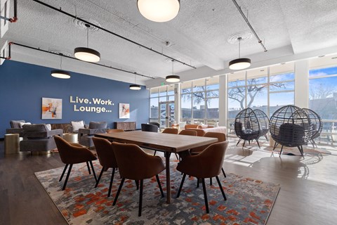 A conference room with a long table surrounded by chairs.