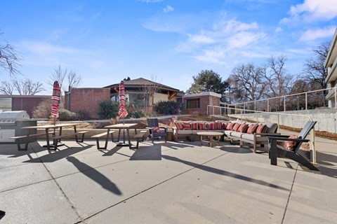 A sunny day at a picnic area with tables and chairs.