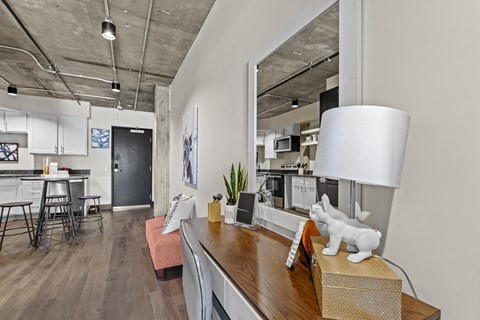 A modern kitchen with a wooden counter and a large mirror on the wall.