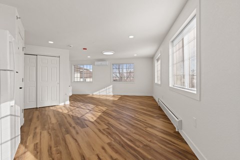 A room with wooden floors and white walls.
