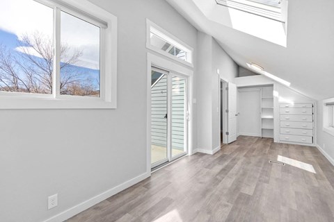 a living room with a large window and a door to a closet