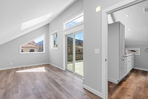 a living room with a sliding glass door to a balcony