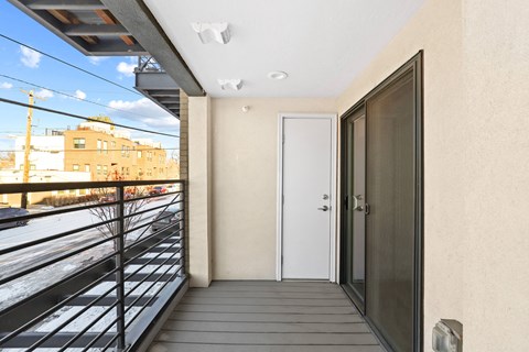 the entrance to a balcony with a door and a view of the city