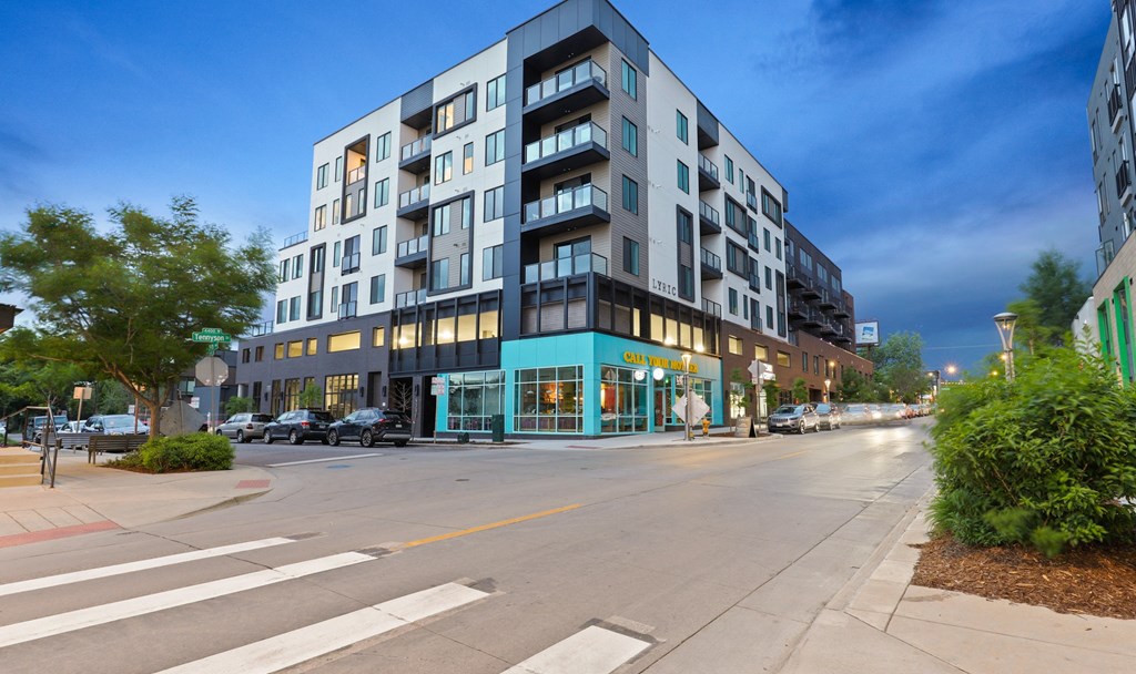 a city street with a large building on the side of the street