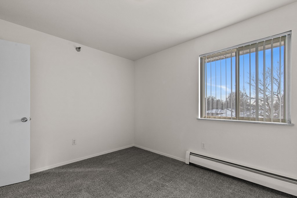 A room with a window and a door.