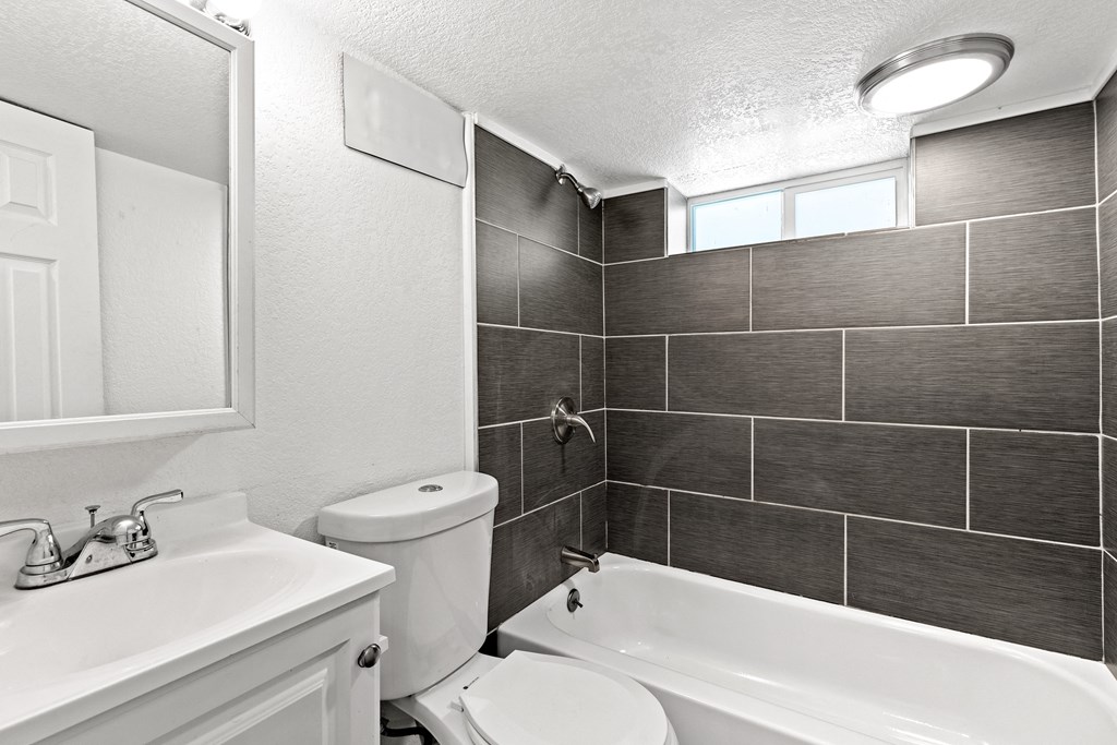 a bathroom with a sink toilet and a bath tub