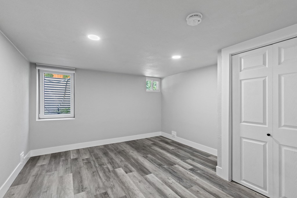 an empty room with white walls and a white door