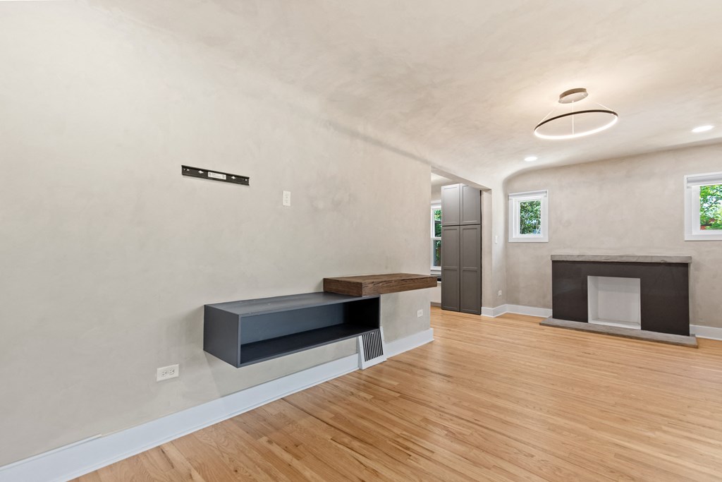 a living room with a fireplace and a wooden floor