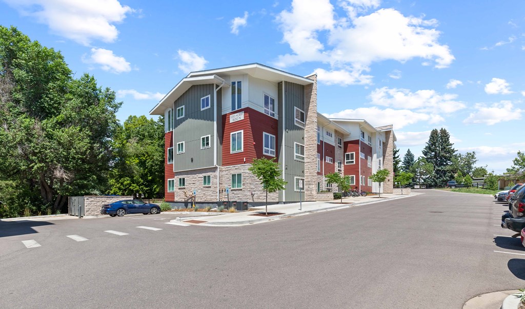 an apartment building with a street in front of it