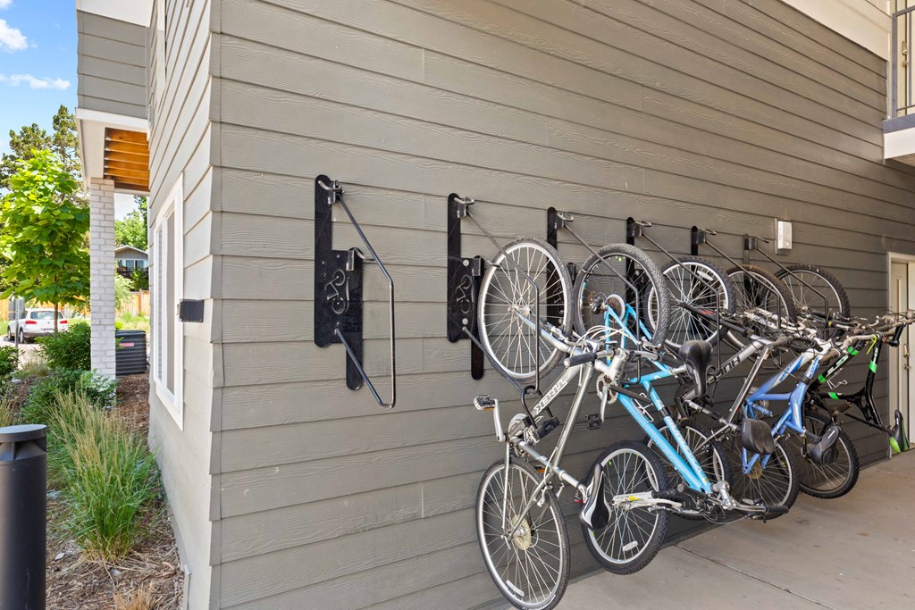 a row of bikes hanging on the side of a building