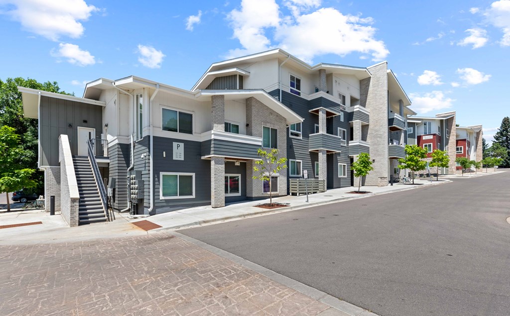 a row of apartment buildings with a street in front of them