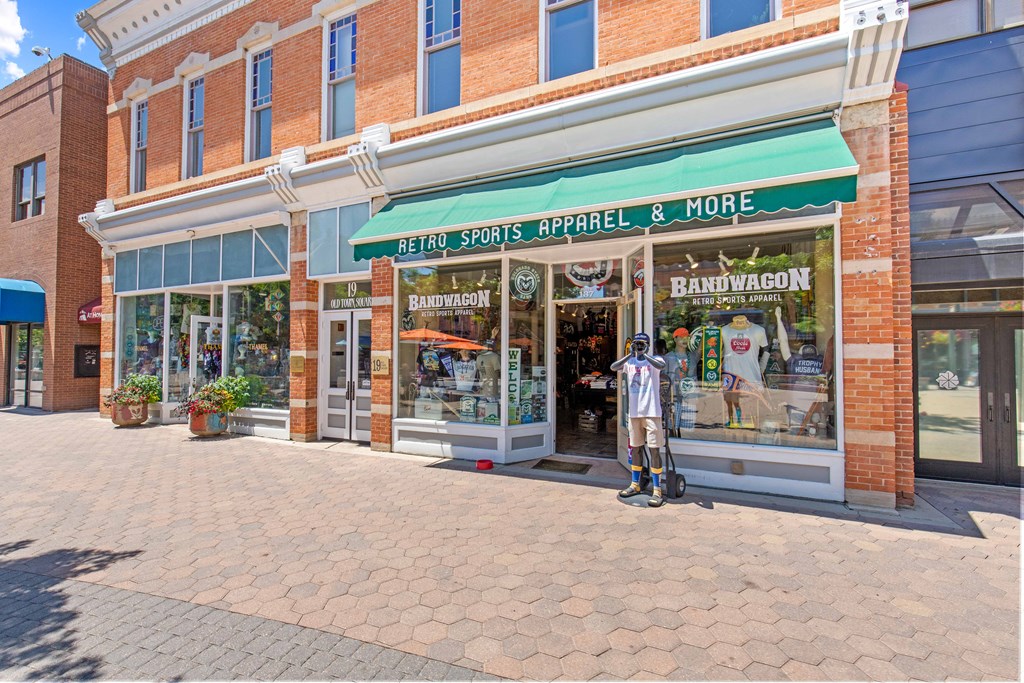 A storefront with a green awning that sells retro sports apparel.