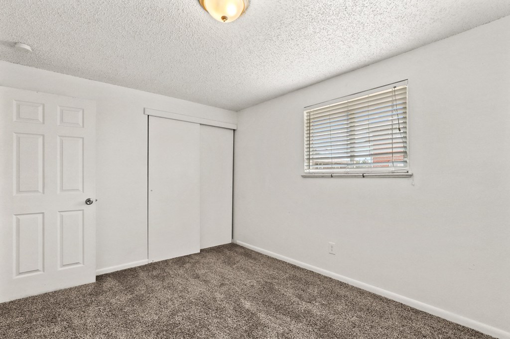 a bedroom with a door and a window