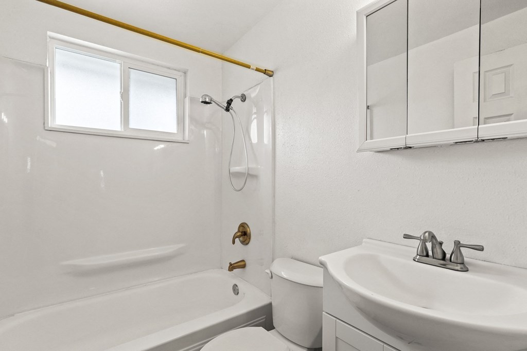 a bathroom with a sink toilet and bathtub
