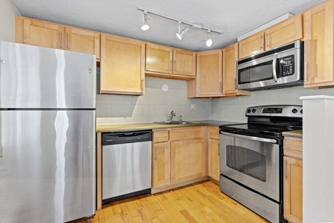 a kitchen with stainless steel appliances and wooden cabinets