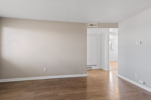 A room with wooden floors and white walls.