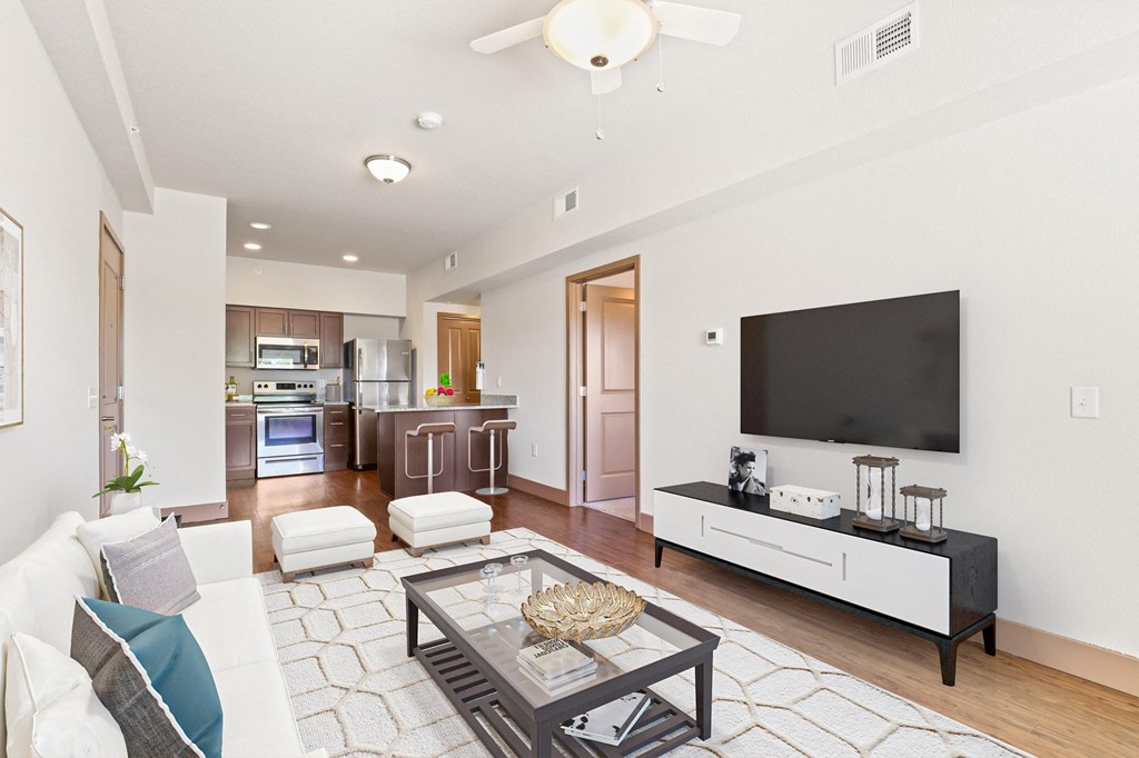 a living room with a couch and a coffee table and a tv