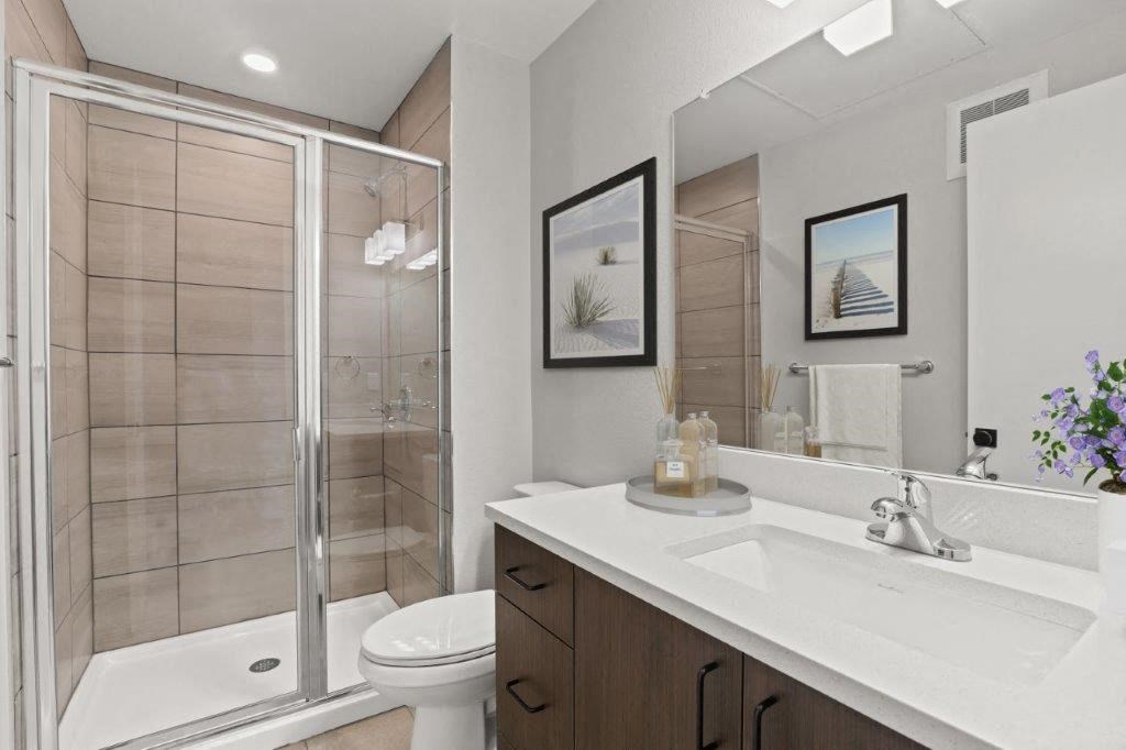 a bathroom with a sink and a shower and a toilet