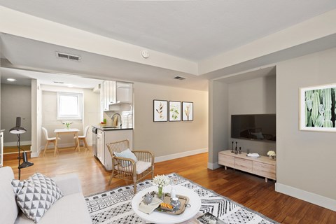 A living room with a white couch and a coffee table in the center.