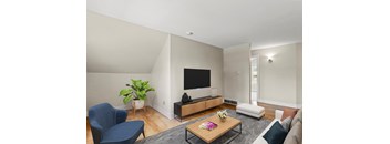 a living room with a tv on the wall and a couch in front of a coffee table