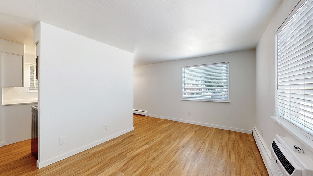 A room with wooden floors and white walls.