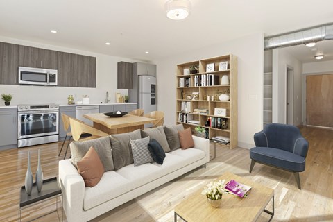 A modern living room with a white sofa and a wooden coffee table.