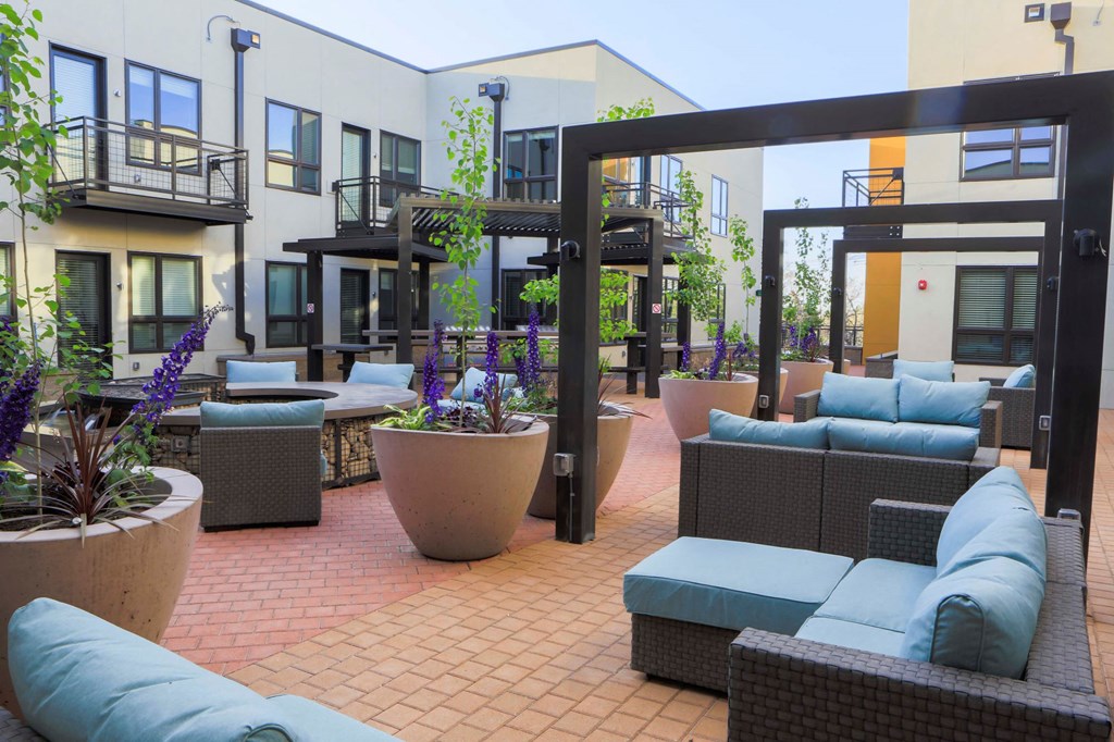 a patio with furniture and potted plants