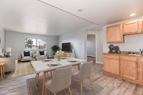 A modern dining room with a white table and chairs.