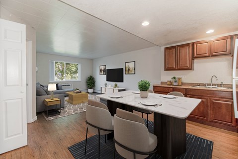A modern kitchen with a dining table and chairs.