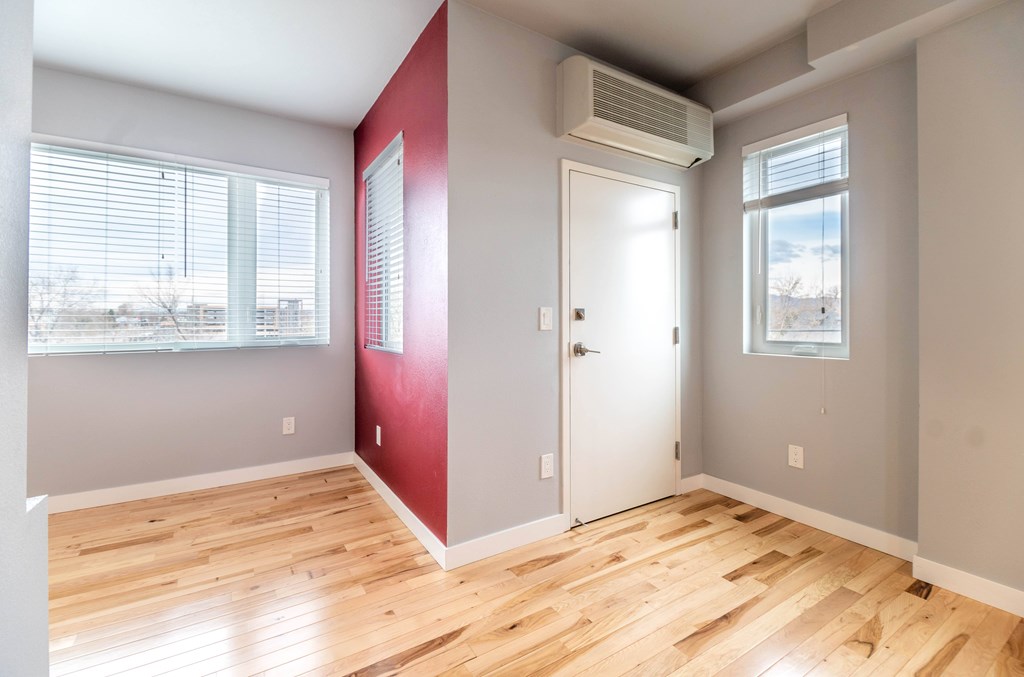 A room with a red wall and a white door.