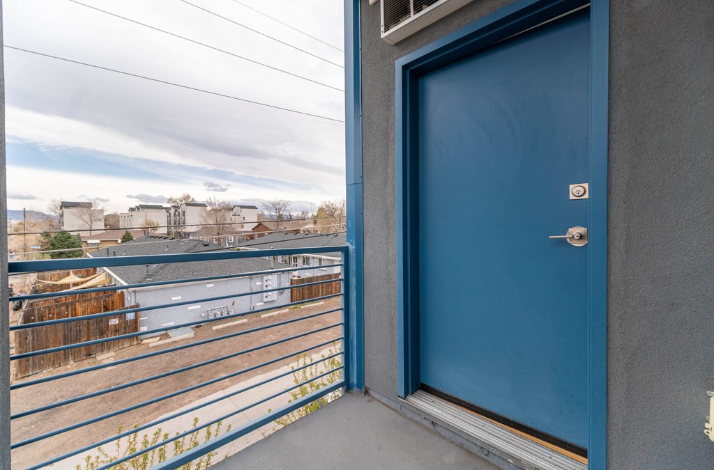 A blue door is closed and has a silver handle.
