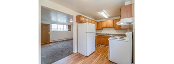 A kitchen with wooden cabinets and white appliances.