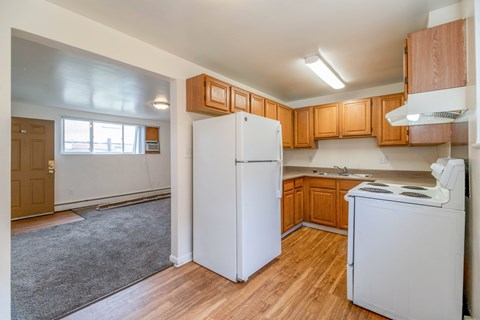 A kitchen with wooden cabinets and white appliances.