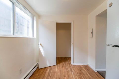 A room with a white door and a window.