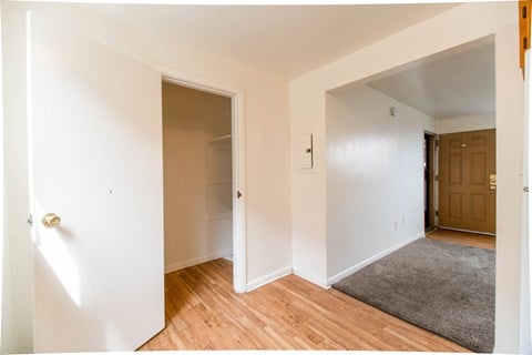 A hallway with a white door and a brown door.